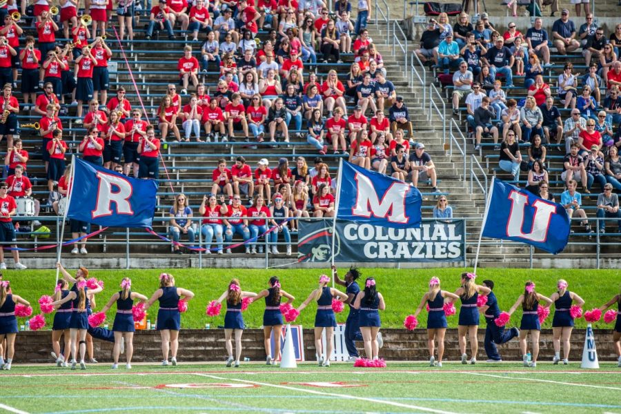 The+Colonials+cheerleaders+carry+the+RMU+letters+out+onto+the+field+before+the+start+of+the+teams+first+home+game+of+2018.+September%2C+17%2C+2018+%28David+Auth%2FRMU+Sentry+Media%29