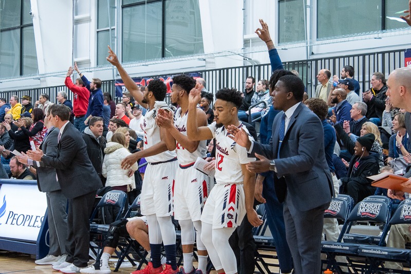 MOON TOWNSHIP — The RMU men’s basketball team celebrates after a made three-pointer against Sacred Heart (Samuel Anthony/RMU Sentry Media).