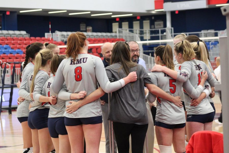 Emma Granger (8) huddles up with her team in a match against Duquesne.