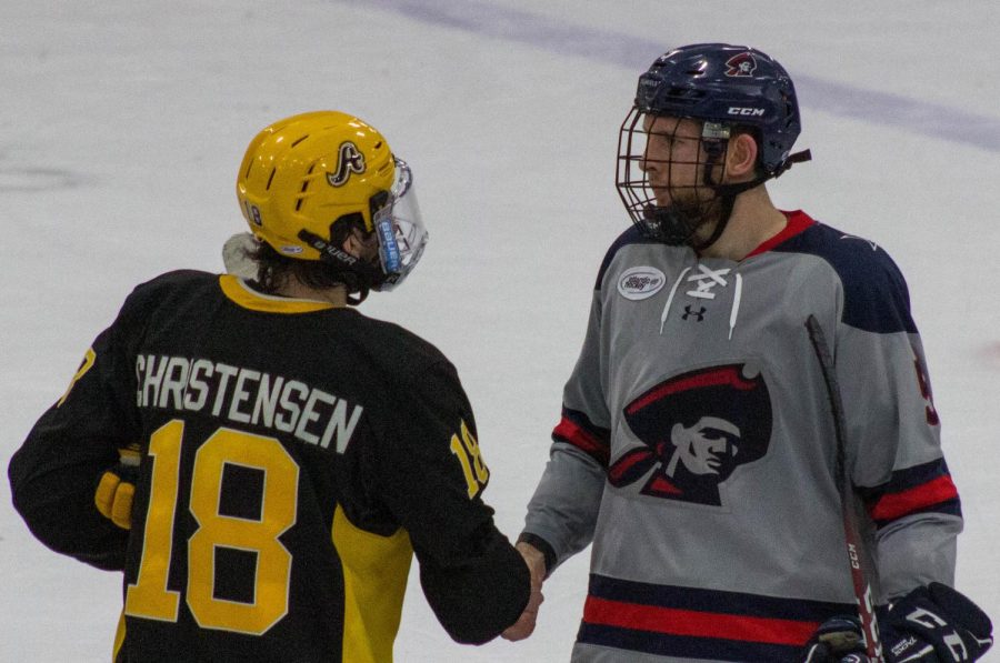 Sean Giles shakes Blake Christensen of AICs hand. Giles signed with Knoxville of the SPHL this week. Photo Credit: Garret Roberts