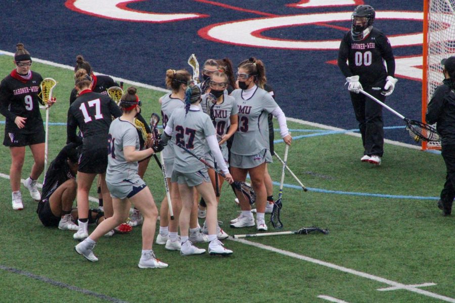 The+womens+lacrosse+team+celebrates+Melanie+Gandys+second-half+goal+on+Sunday%2C+one+of+her+seven+points.+Photo+Credit%3A+Tyler+Gallo