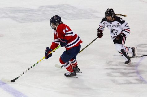 Anjelica Diffendal moves the puck past Skylar Fontaine of Northeastern in the 2020 NCAA Womens Hockey Tournament. Photo credit: Nathan Breisinger