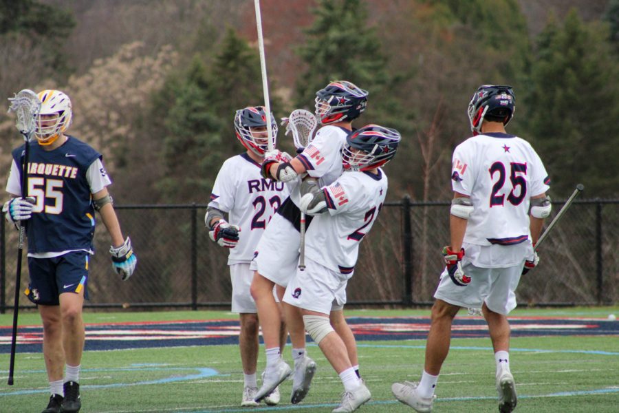 James Leary is lifted up by his teammate after his goal late in the third quarter on Saturday. Photo credit: Tyler Gallo
