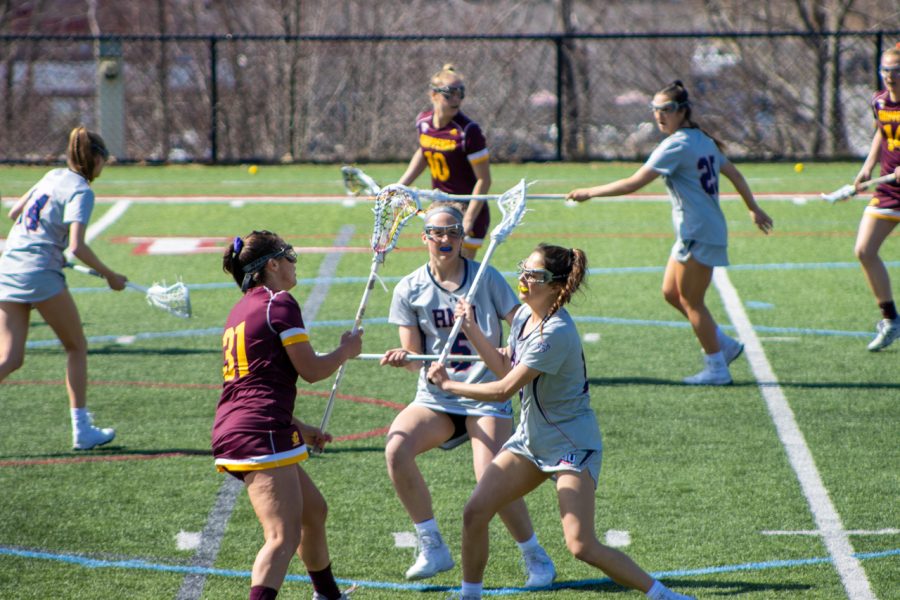Maggie+Diebold+and+two+RMU+players+fight+for+a+ball+in+Wednesdays+game.+Photo+credit%3A+Bailey+Noel