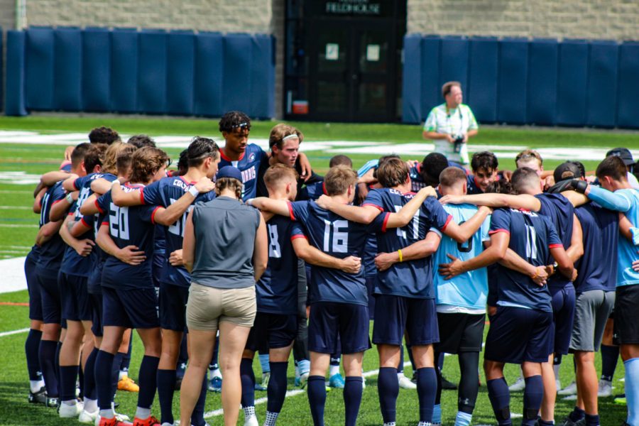 Mens soccer huddles before their game at Duquesne. Photo credit: Ethan Morrison