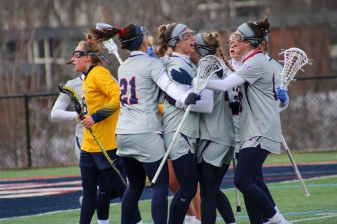 Womens lacrosse celebrates a goal against Canisius. Photo credit: Tyler Gallo