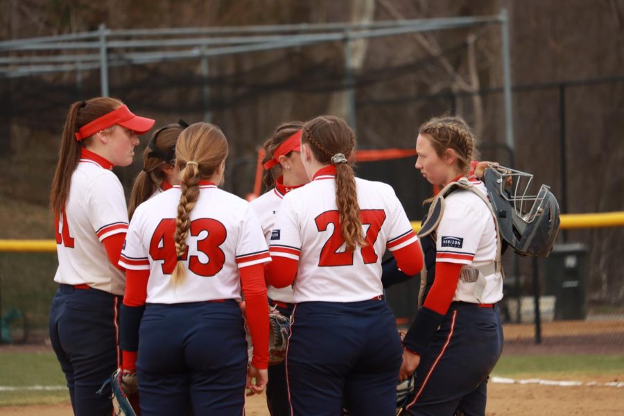 The team gathers around the mound during a game against Cleveland State on April 3, 2022