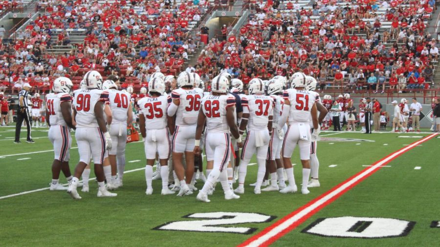 The team huddles before a play during Saturdays 31-14 loss at Yager Stadium in Oxford, Ohio