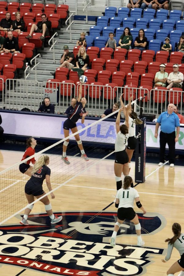 Junior Annie Monoco spikes the ball over the net in the first of two games for the Colonials on Friday. Photo credit: Bailey Noel