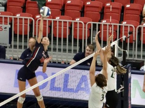 Junior Annie Monaco spikes the ball over the net in the first of two games for the Colonials Friday afternoon.