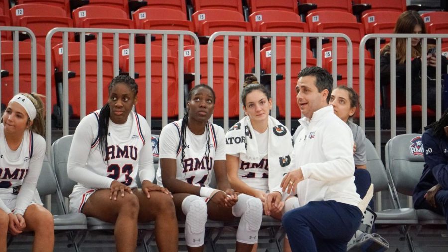 Head coach Charlie Buscaglia talk to (left to right) Mackenzie Amalia, Phoenix Gedeon, Rebecca Dwomoh and Alejandra Mastral on the bench in the win vs IUPUI