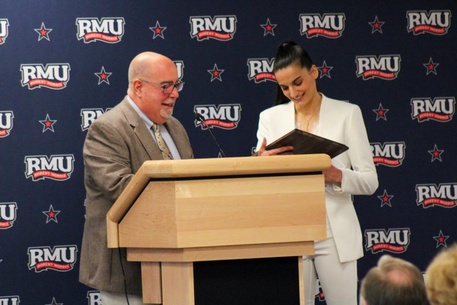 Former RMU womens basketball player Anna Niki Stamolamprou receives Hall of Fame plaque from Chris Shovlin.